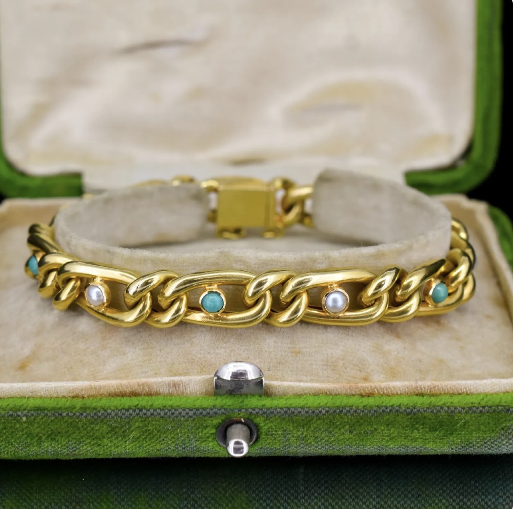 An antique 15ct yellow gold curb link bracelet inset with alternating pearls and cabochon turquoise stones, featuring a fitted safety chain. View II