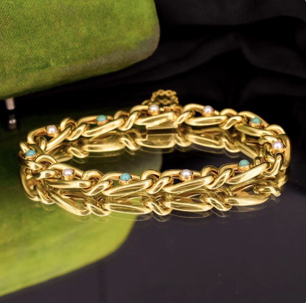 An antique 15ct yellow gold curb link bracelet inset with alternating pearls and cabochon turquoise stones, featuring a fitted safety chain. View VII