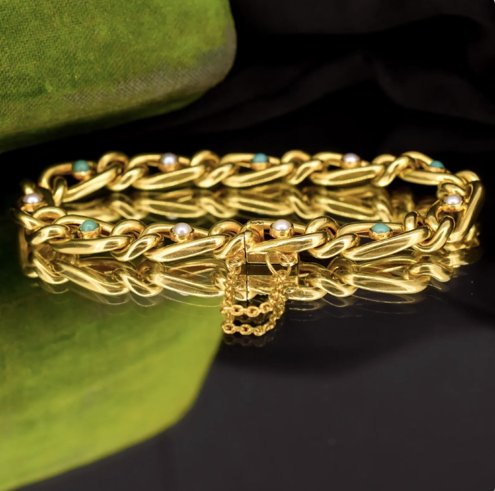 An antique 15ct yellow gold curb link bracelet inset with alternating pearls and cabochon turquoise stones, featuring a fitted safety chain. View VIII