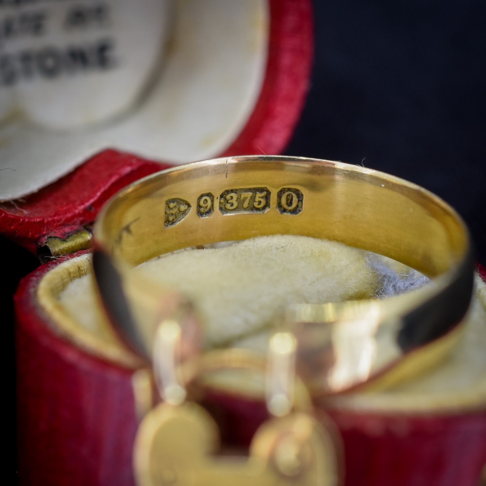 A late Victorian 9ct yellow gold band ring featuring a suspended heart-shaped padlock charm with keyhole detail. View III