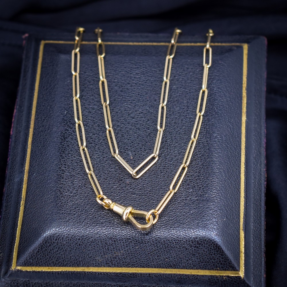 An antique 9ct yellow gold paperlink chain necklace featuring uniform elongated rectangular links and a swivel dog clip clasp.