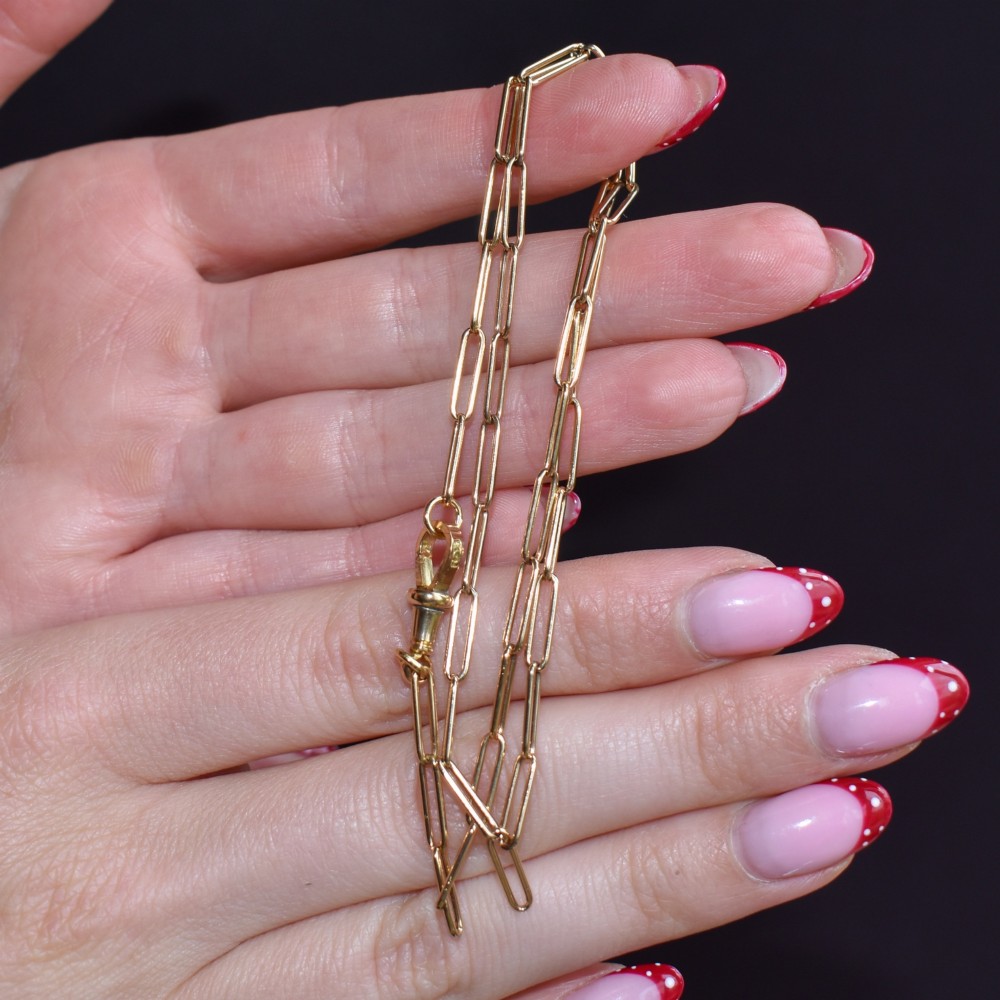 An antique 9ct yellow gold paperlink chain necklace featuring uniform elongated rectangular links and a swivel dog clip clasp. View IX