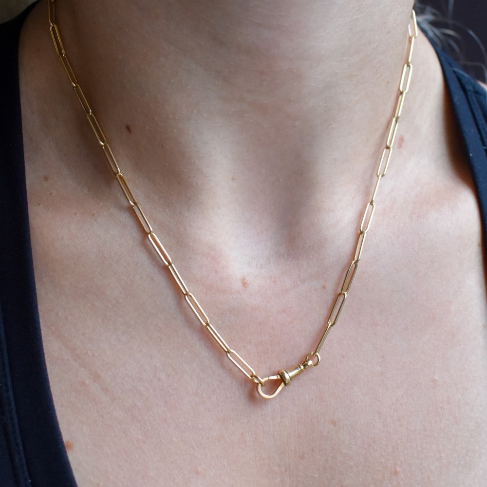 An antique 9ct yellow gold paperlink chain necklace featuring uniform elongated rectangular links and a swivel dog clip clasp. View XI