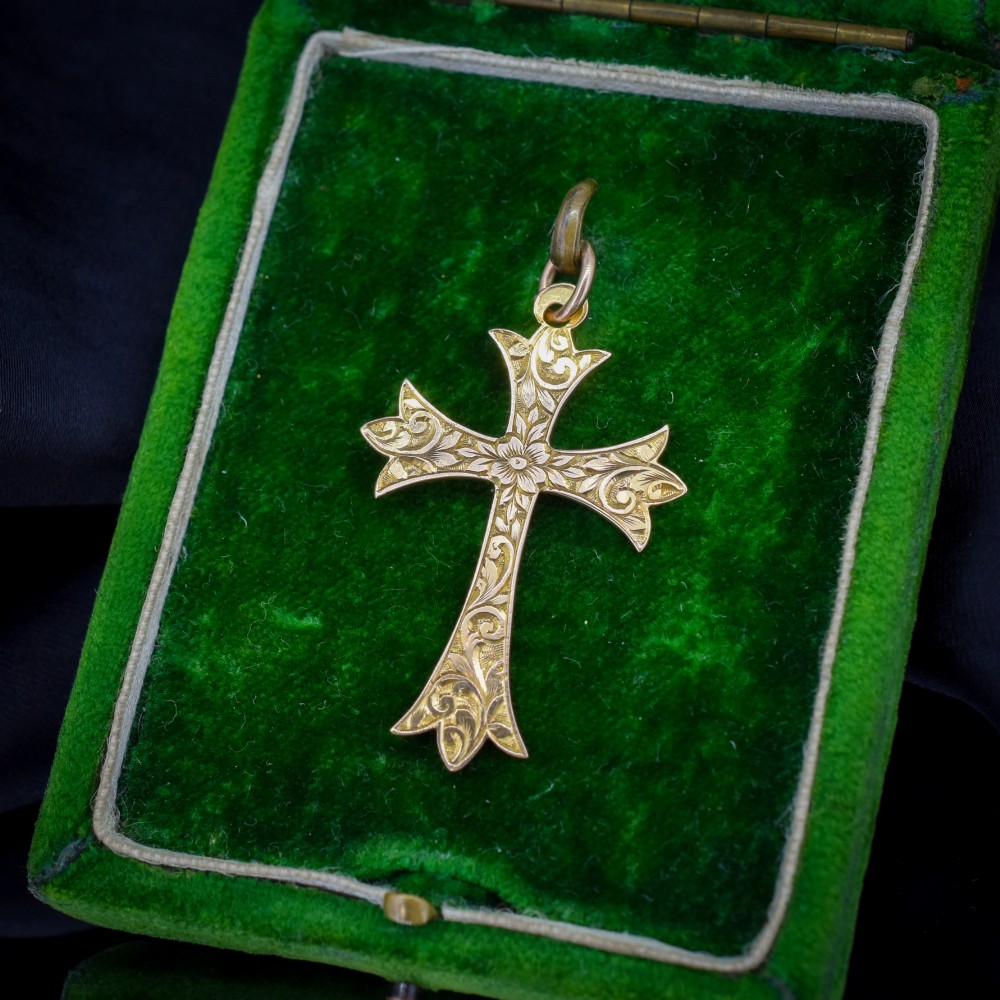 An Edwardian 9ct yellow gold cross pendant with intricate foliate hand engraving and a top suspension ring. View II