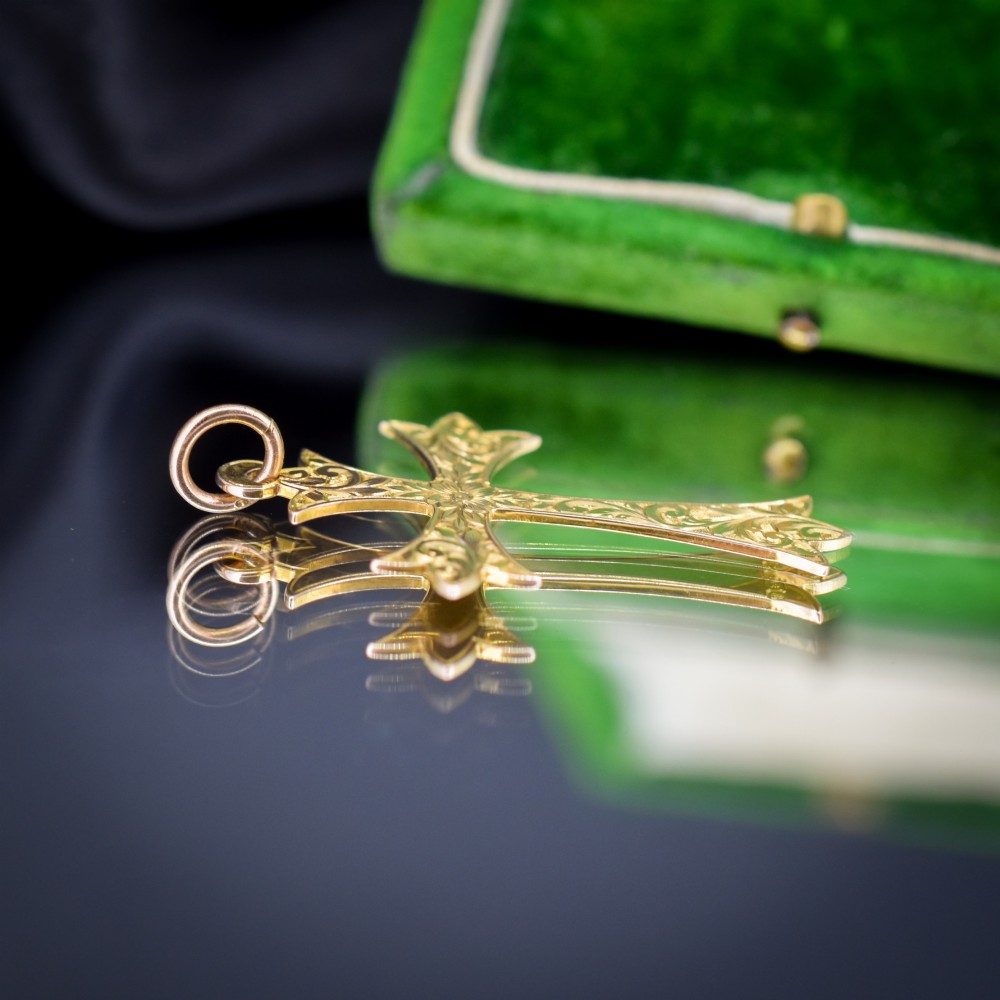 An Edwardian 9ct yellow gold cross pendant with intricate foliate hand engraving and a top suspension ring. View III