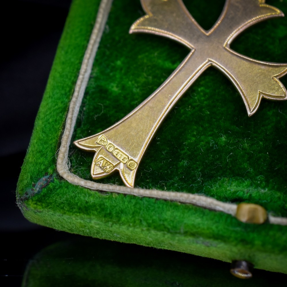 An Edwardian 9ct yellow gold cross pendant with intricate foliate hand engraving and a top suspension ring. View V
