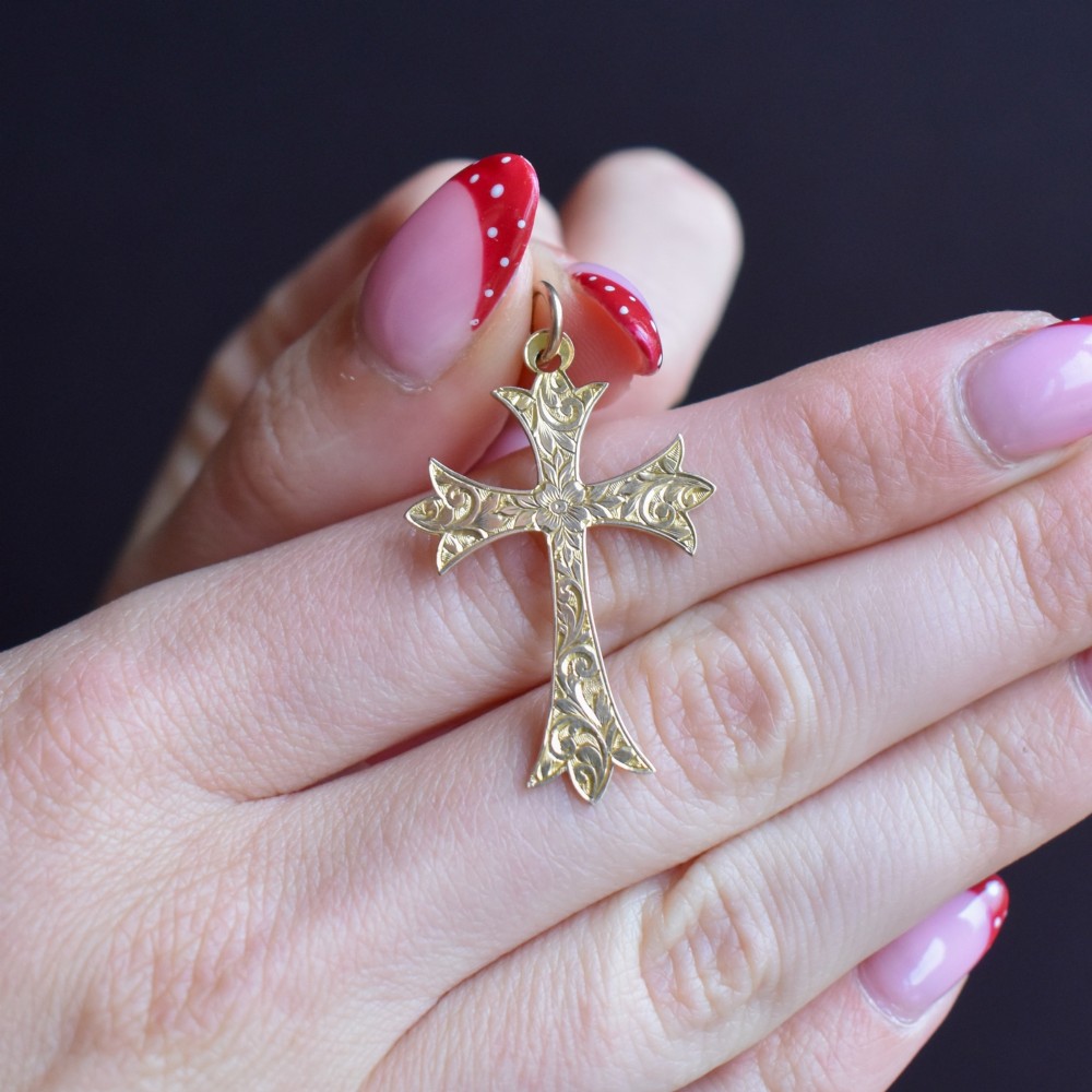 An Edwardian 9ct yellow gold cross pendant with intricate foliate hand engraving and a top suspension ring. View VI