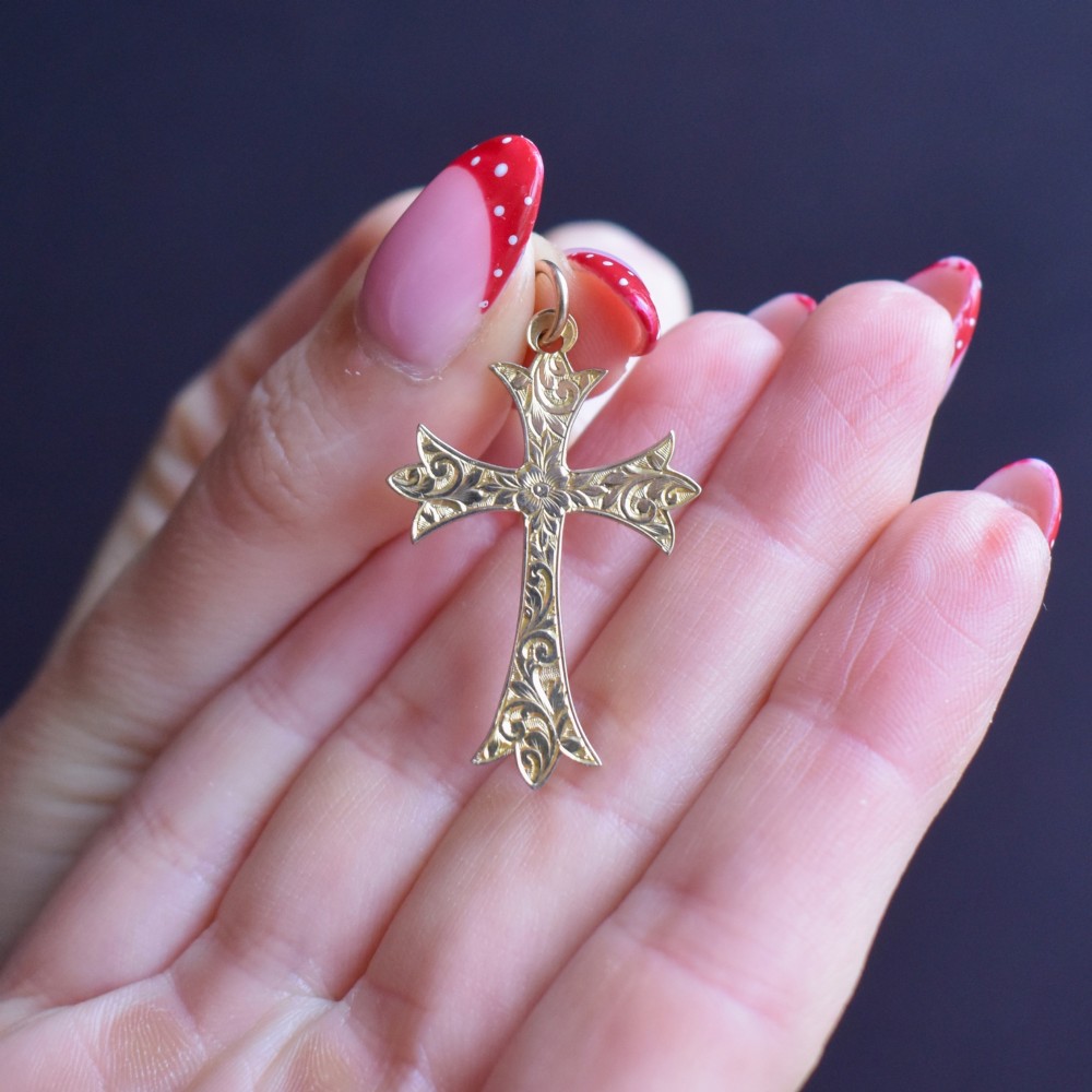 An Edwardian 9ct yellow gold cross pendant with intricate foliate hand engraving and a top suspension ring. View VII