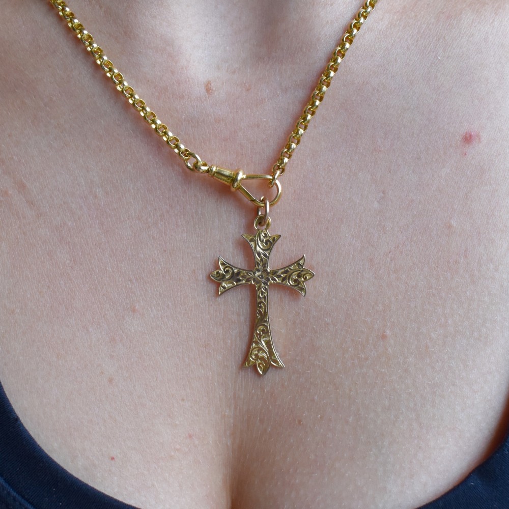 An Edwardian 9ct yellow gold cross pendant with intricate foliate hand engraving and a top suspension ring. View VIII
