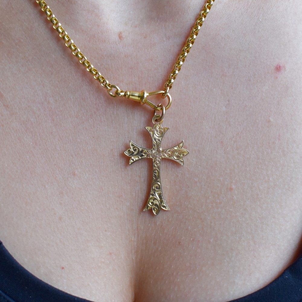 An Edwardian 9ct yellow gold cross pendant with intricate foliate hand engraving and a top suspension ring. View IX
