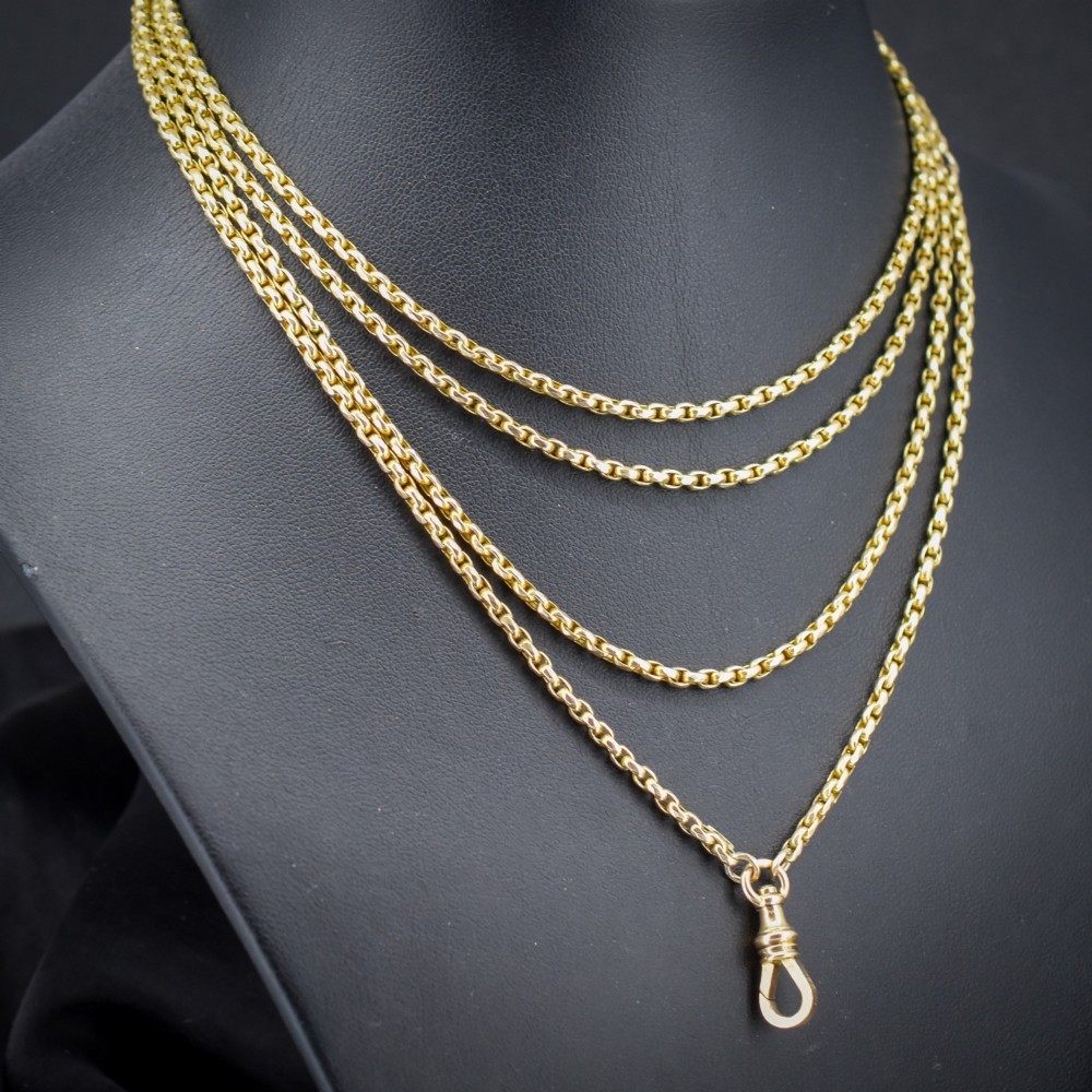 An antique 10ct yellow gold long guard chain featuring faceted oval links and a dog clip fastener. View III