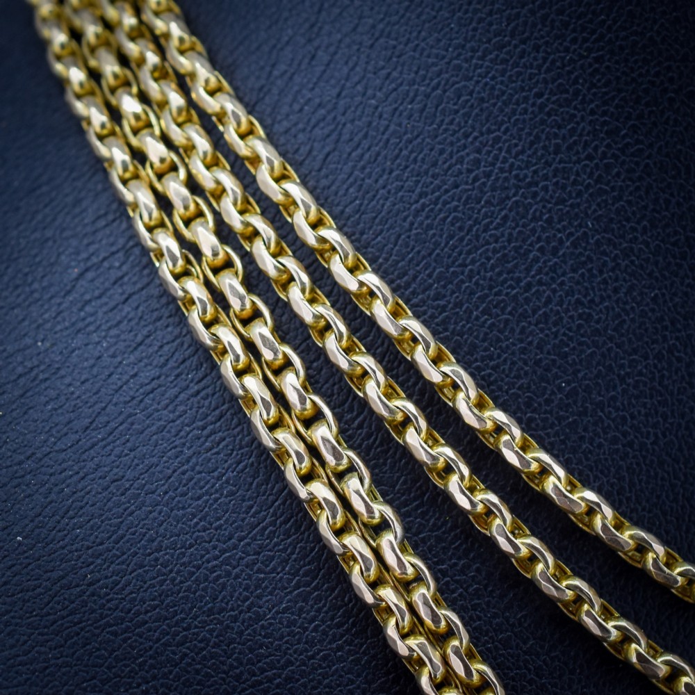 An antique 10ct yellow gold long guard chain featuring faceted oval links and a dog clip fastener. View IV