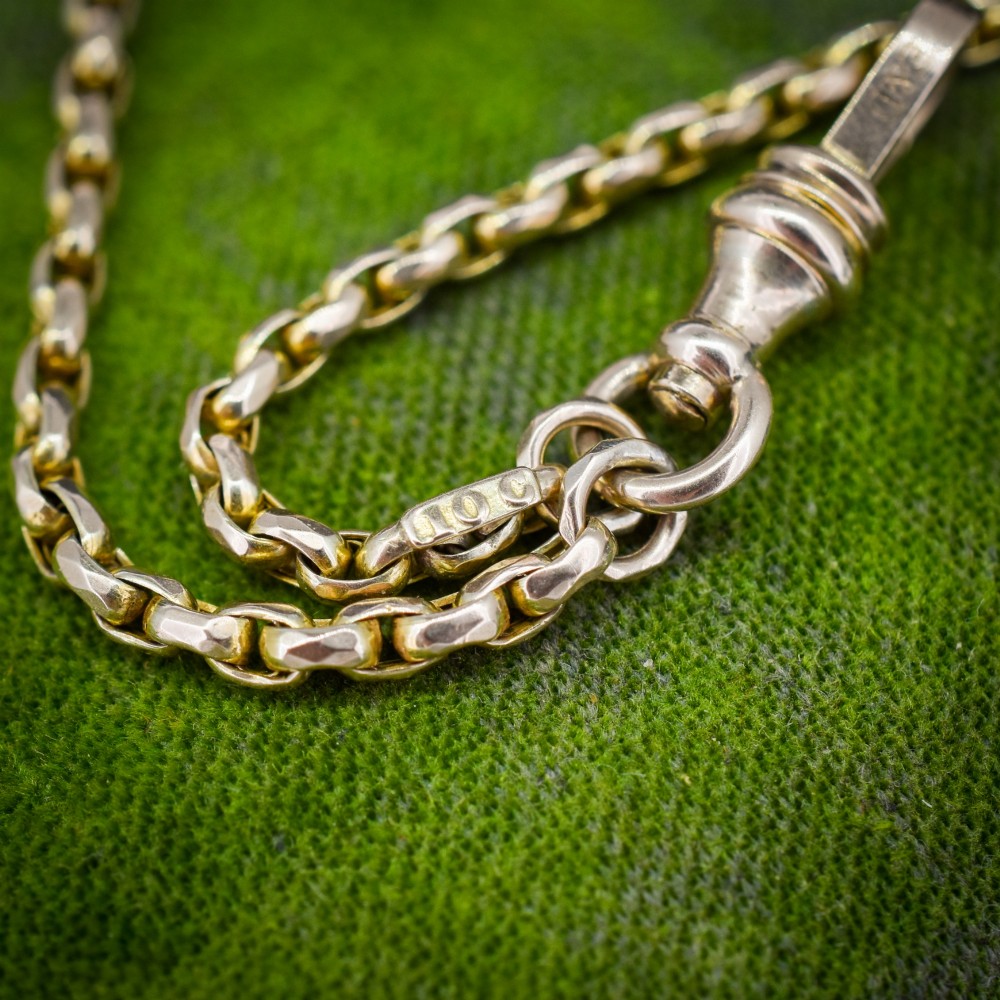 An antique 10ct yellow gold long guard chain featuring faceted oval links and a dog clip fastener. View VIII