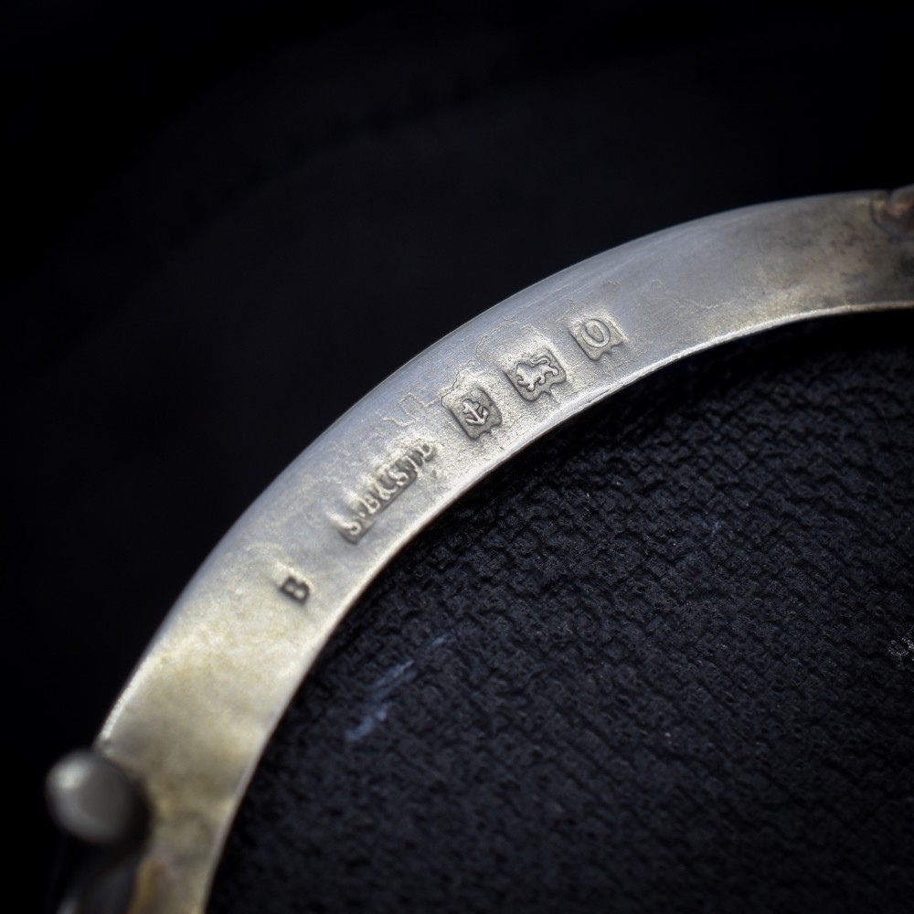 An oval sterling silver trinket box with a smooth polished hinged lid supported on four small cabriole feet. View IV