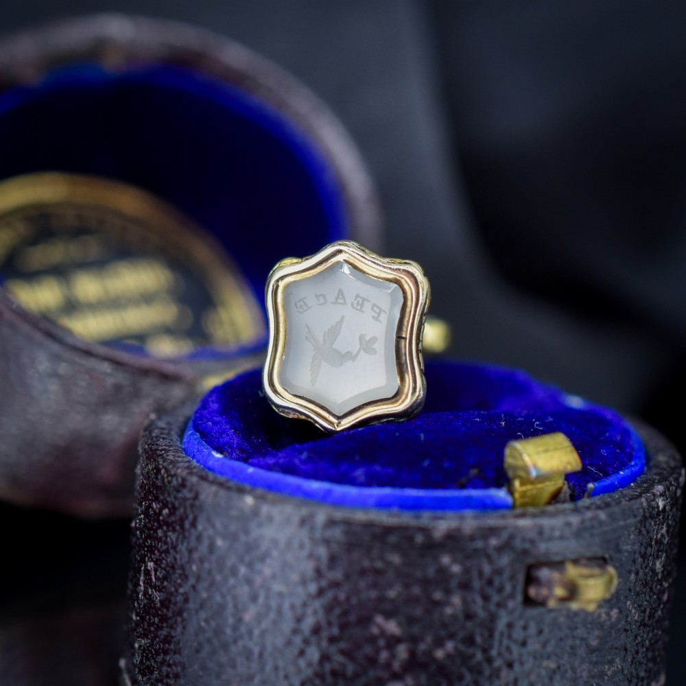 An antique gold fob seal featuring a carved chalcedony intaglio displaying a dove of peace carrying an olive branch above a reversed inscription. View II