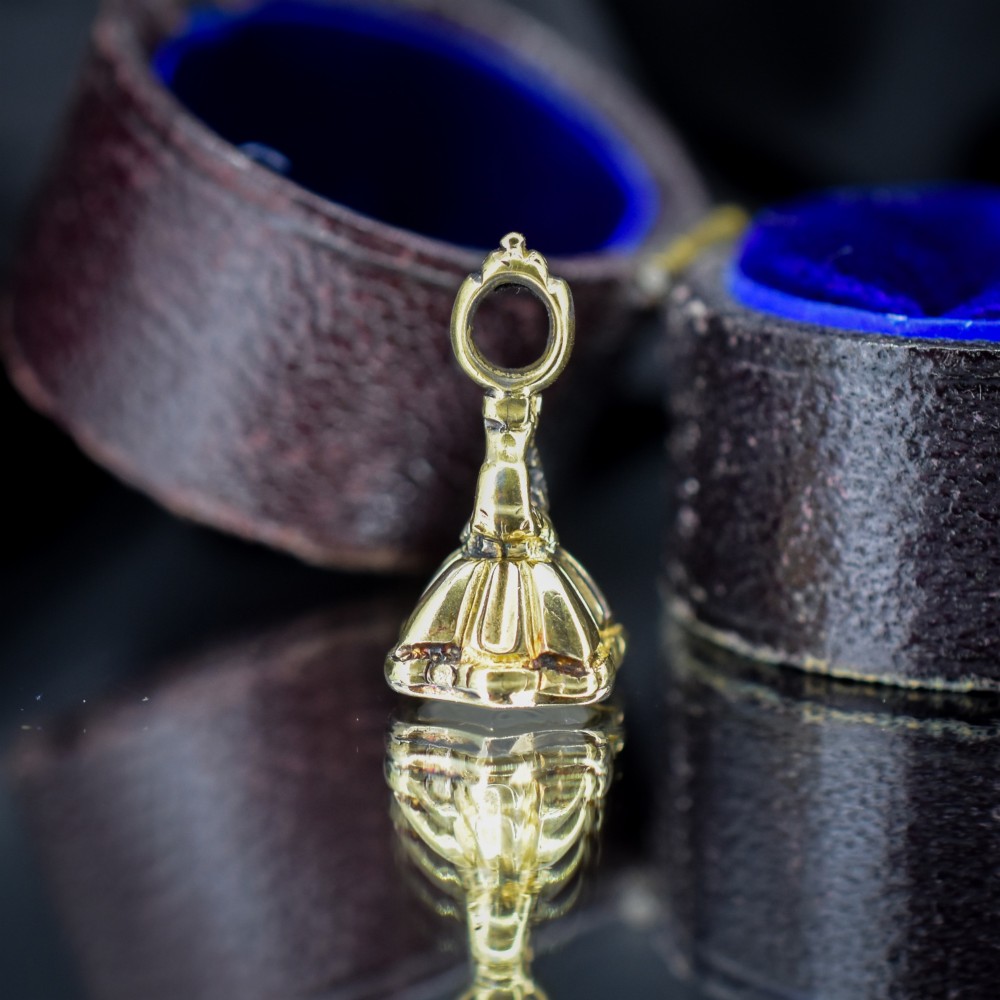 An antique gold fob seal featuring a carved chalcedony intaglio displaying a dove of peace carrying an olive branch above a reversed inscription. View IV