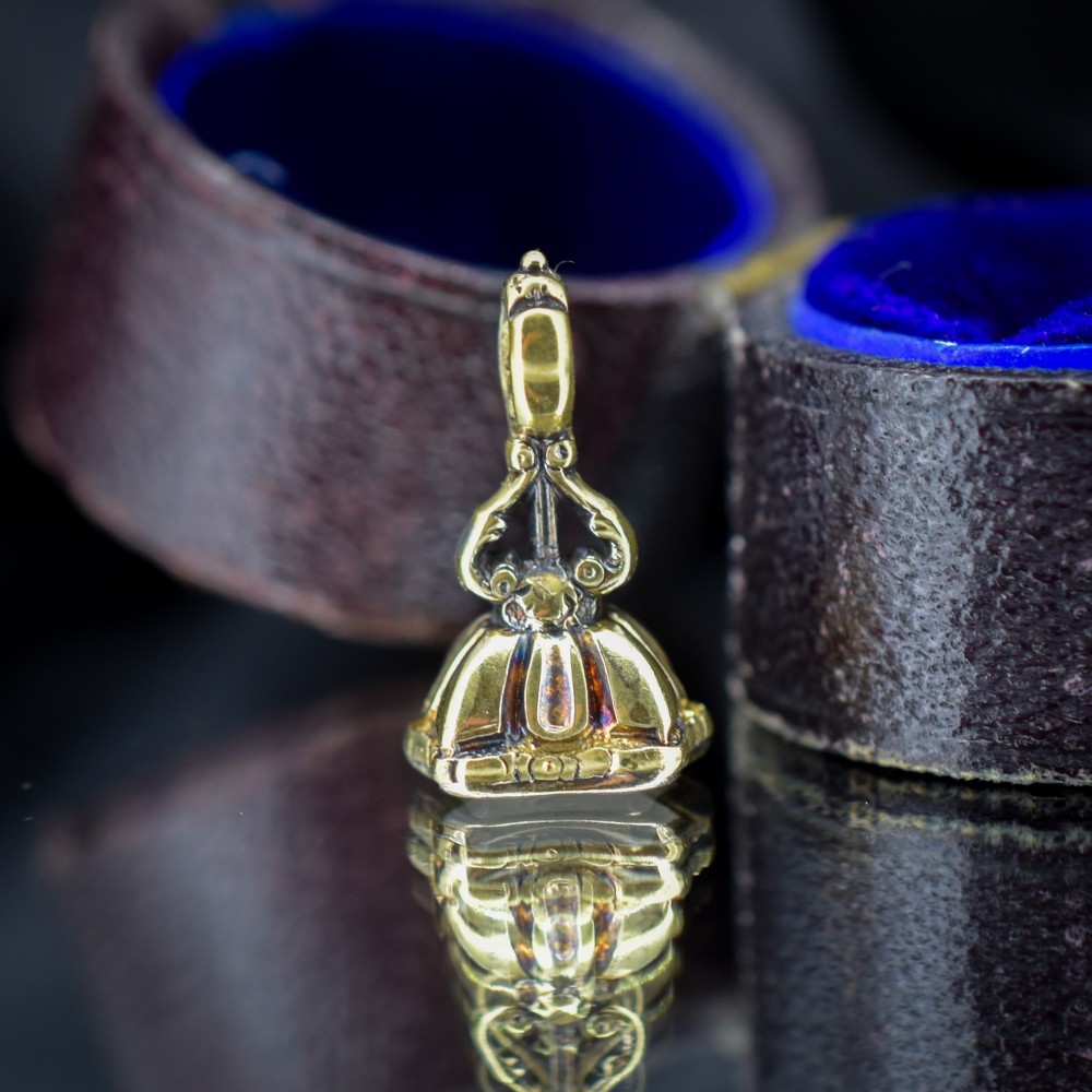 An antique gold fob seal featuring a carved chalcedony intaglio displaying a dove of peace carrying an olive branch above a reversed inscription. View V