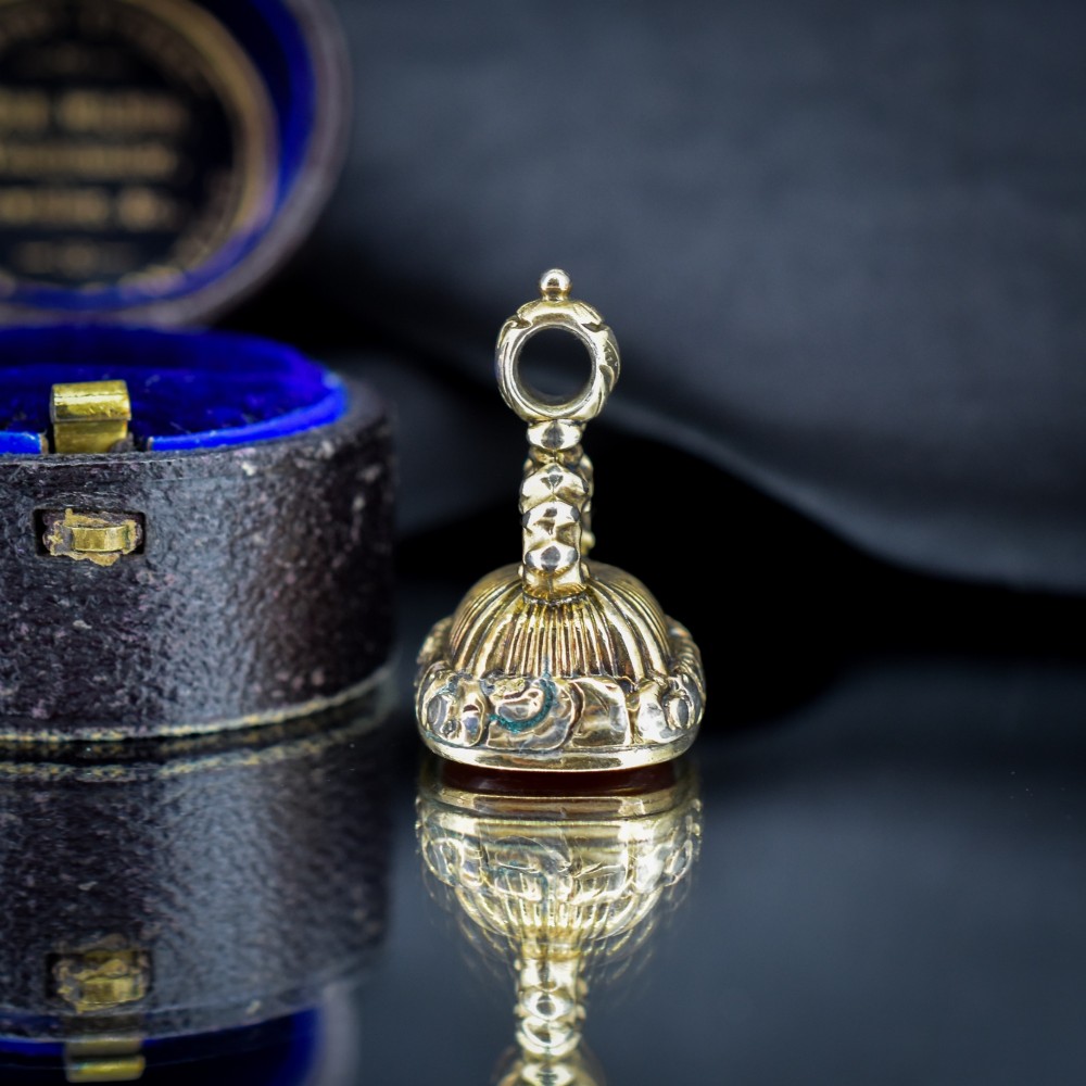 A Georgian gold fob seal set with a red carnelian intaglio engraved with a sailing ship and the French inscription Telle Est La Vie. View VI