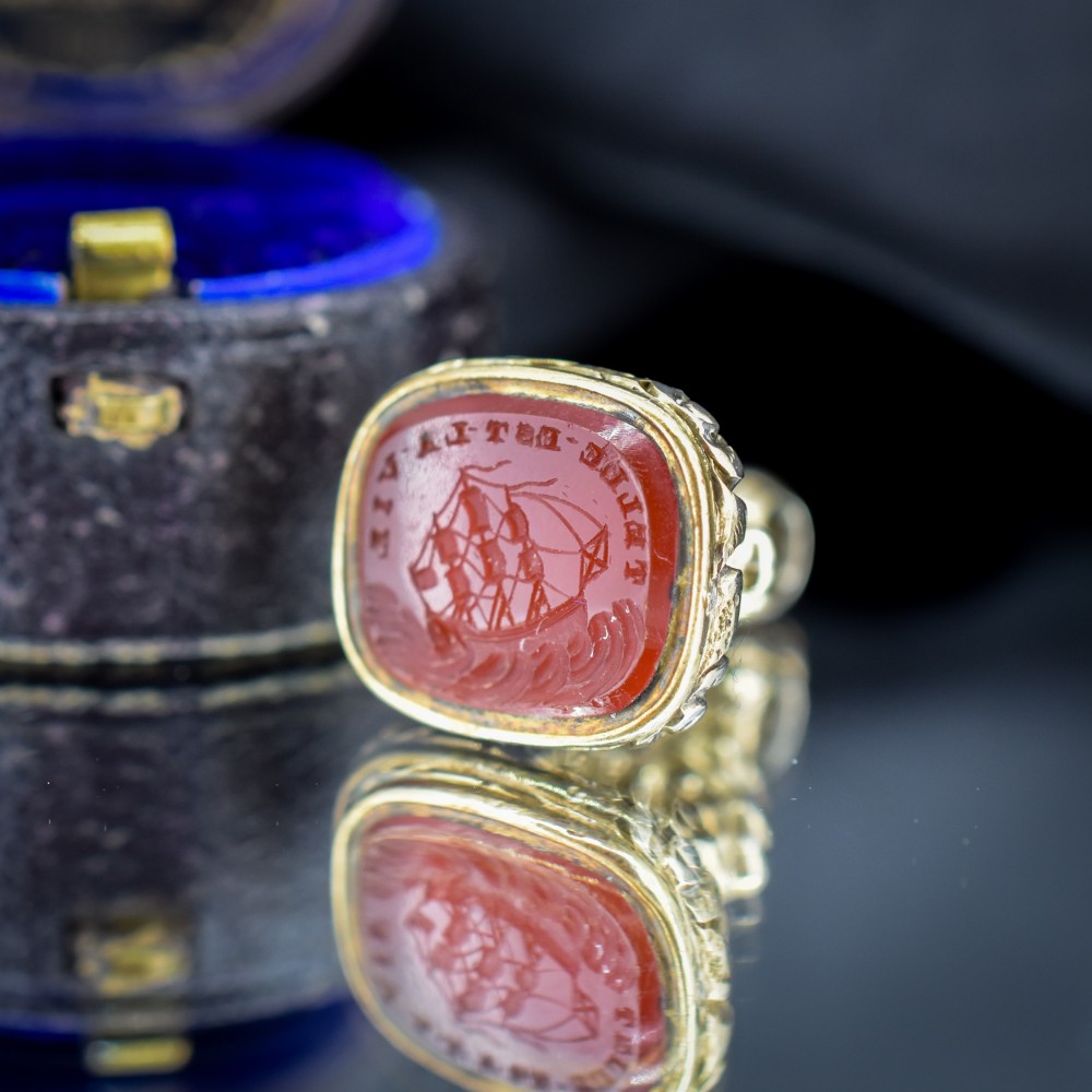 A Georgian gold fob seal set with a red carnelian intaglio engraved with a sailing ship and the French inscription Telle Est La Vie. View VII