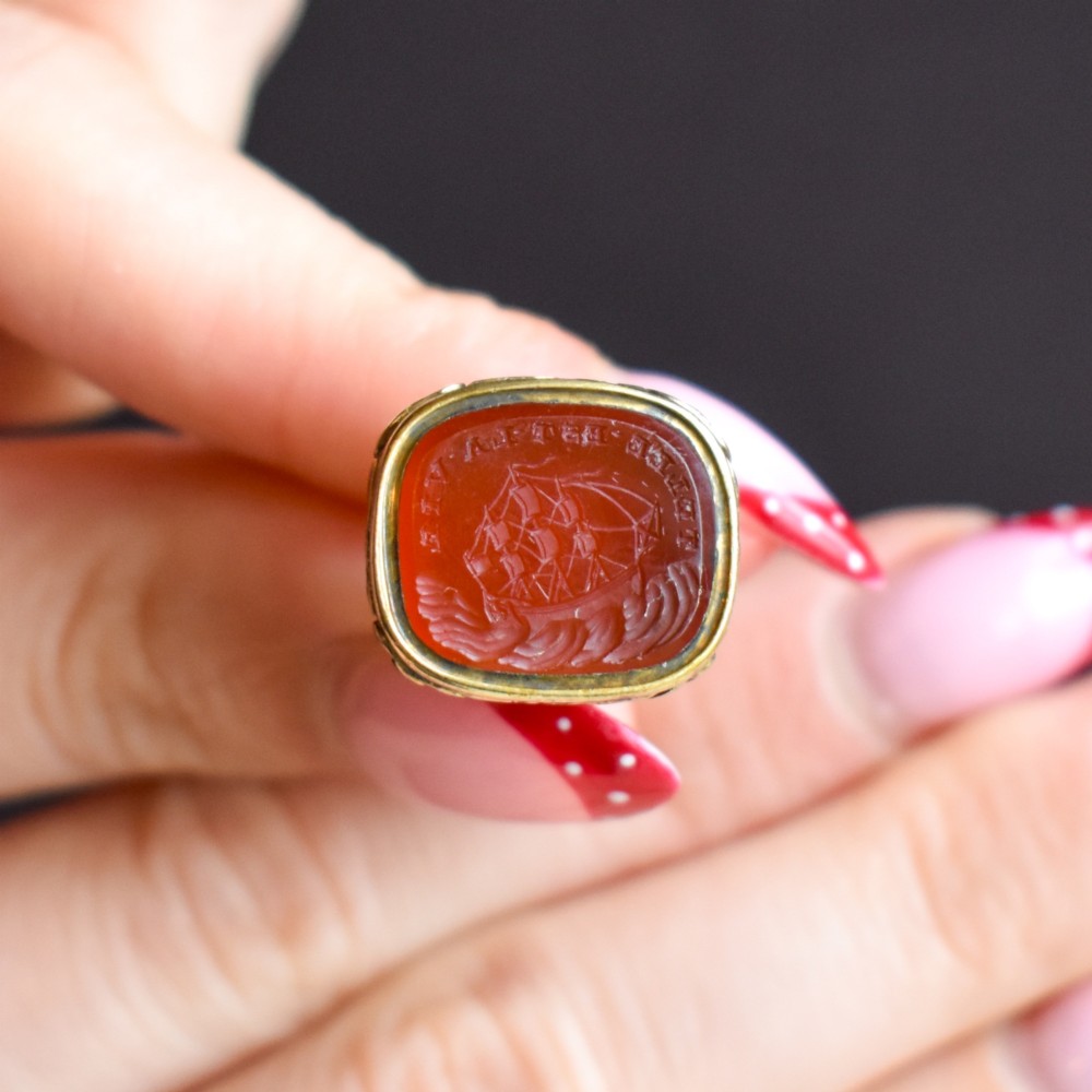 A Georgian gold fob seal set with a red carnelian intaglio engraved with a sailing ship and the French inscription Telle Est La Vie. View VIII
