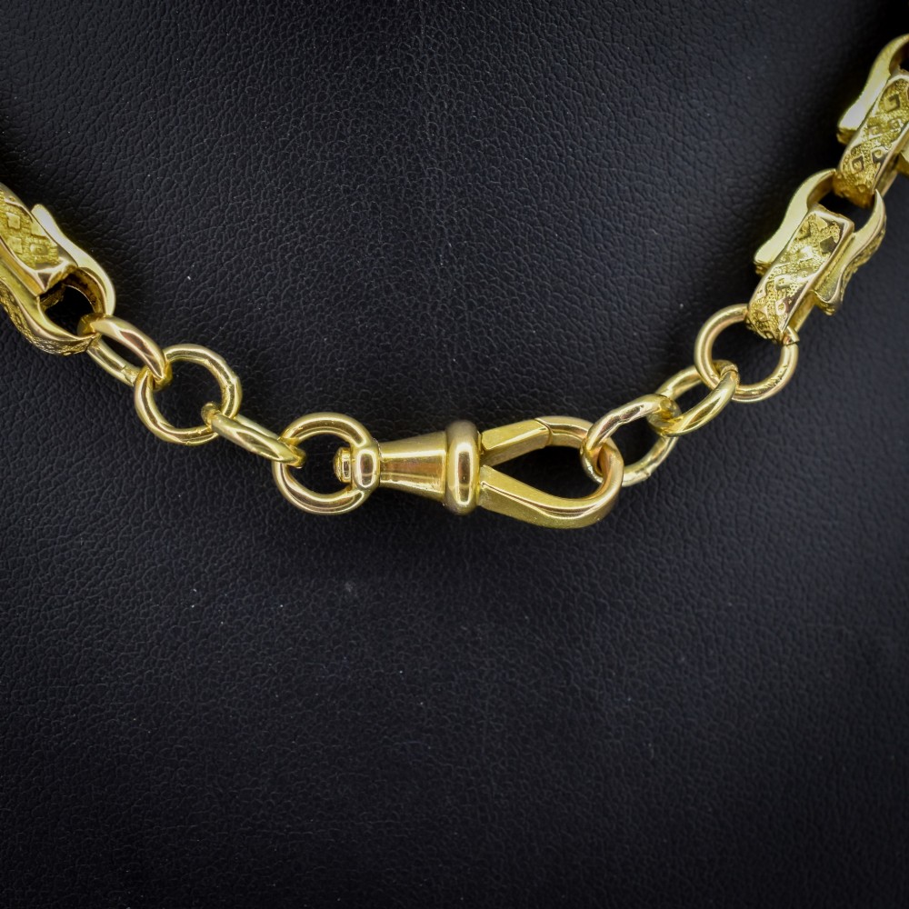 An antique 10ct yellow gold tulip link chain necklace featuring textured engraved links and a swivel dog clip clasp. View II
