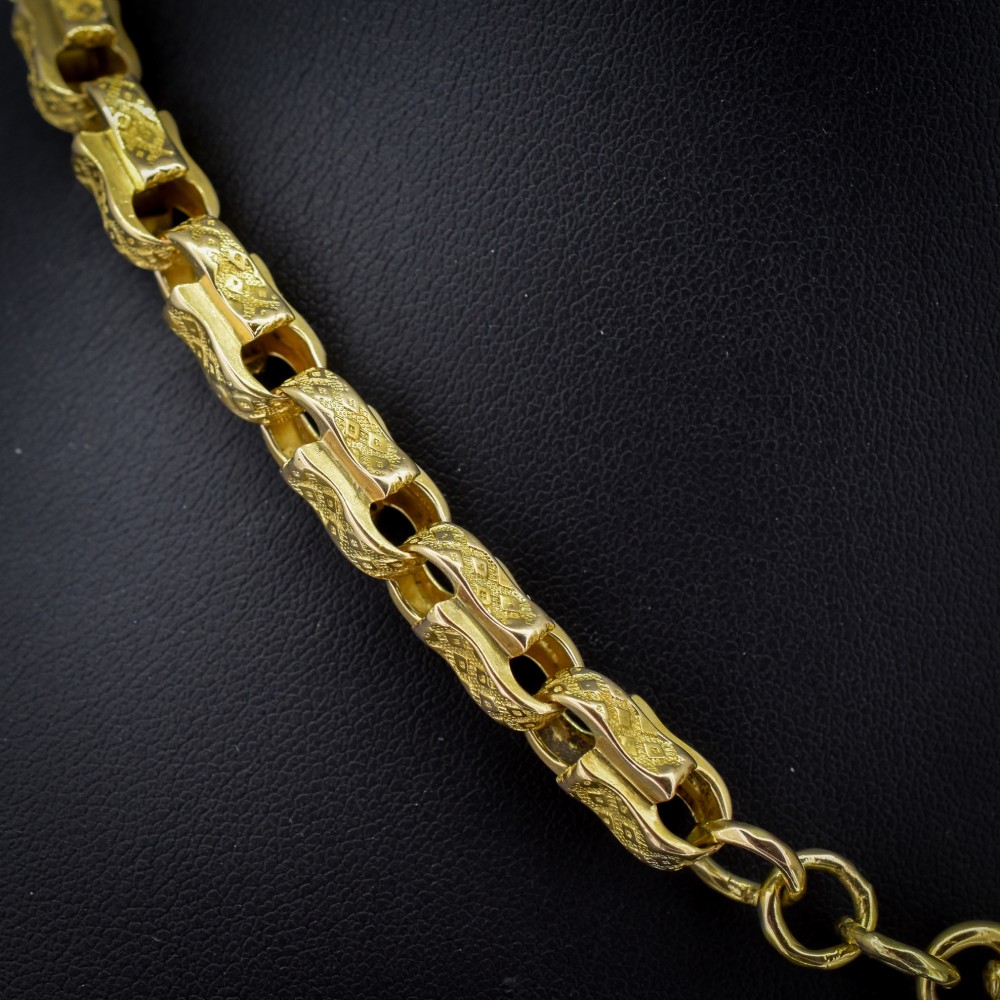 An antique 10ct yellow gold tulip link chain necklace featuring textured engraved links and a swivel dog clip clasp. View III