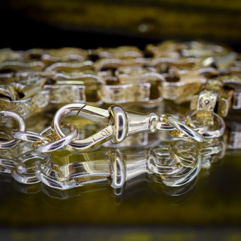 An antique 10ct yellow gold tulip link chain necklace featuring textured engraved links and a swivel dog clip clasp. View VII