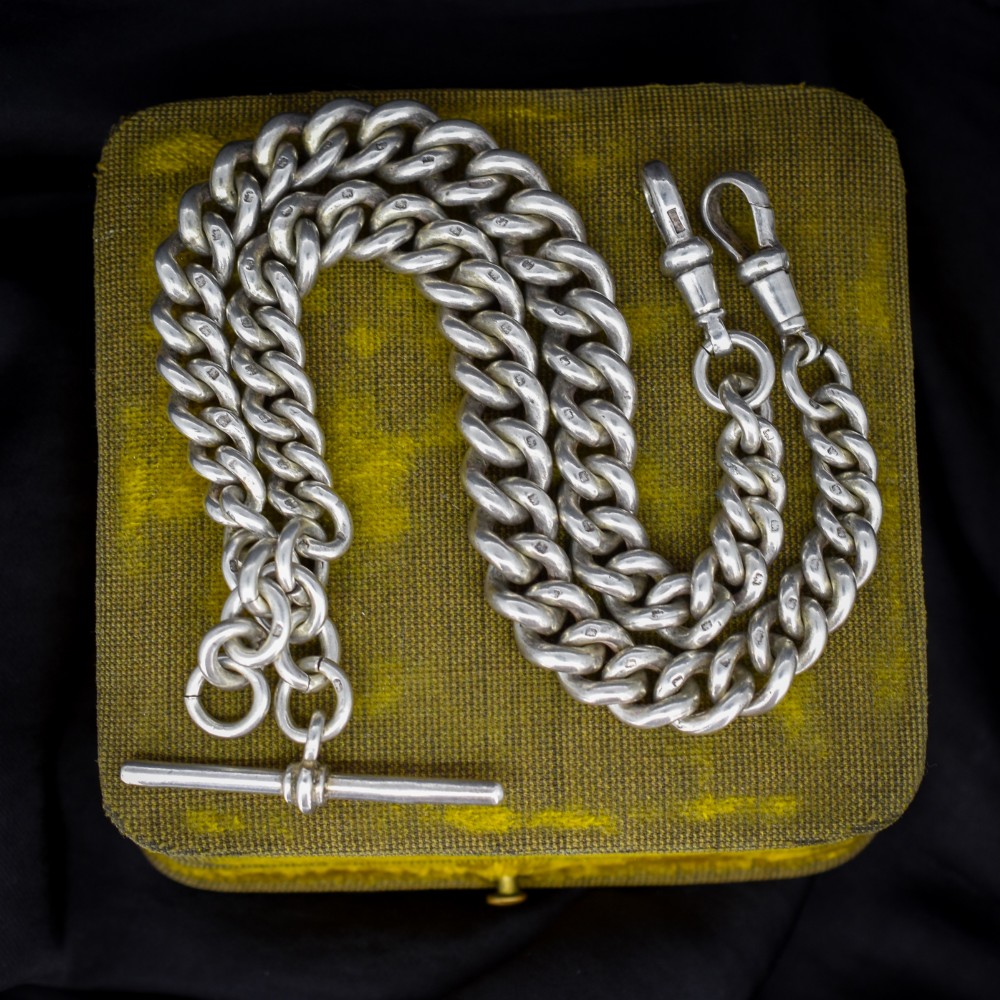 An antique sterling silver Albert watch chain featuring heavy curb links, double swivel clasps, and a central T-bar attachment.