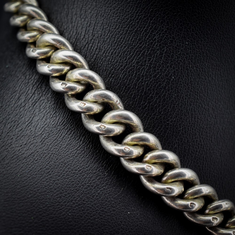 An antique sterling silver Albert watch chain featuring heavy curb links, double swivel clasps, and a central T-bar attachment. View III