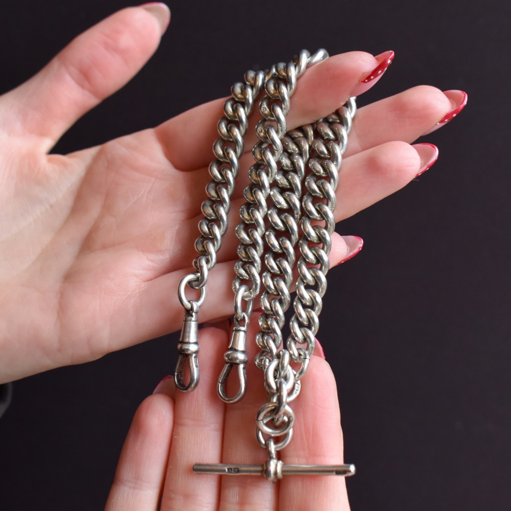 An antique sterling silver Albert watch chain featuring heavy curb links, double swivel clasps, and a central T-bar attachment. View VII