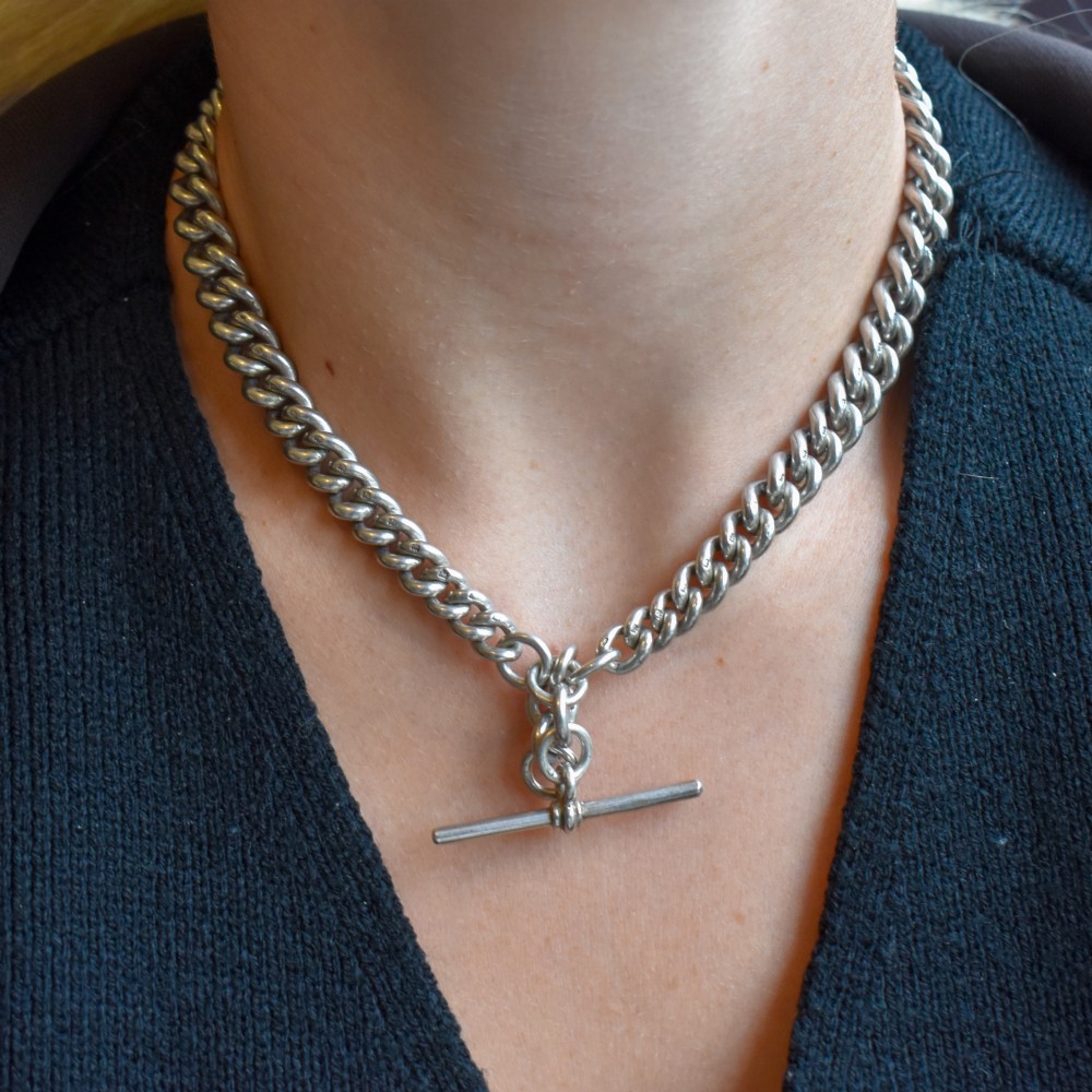 An antique sterling silver Albert watch chain featuring heavy curb links, double swivel clasps, and a central T-bar attachment. View VIII
