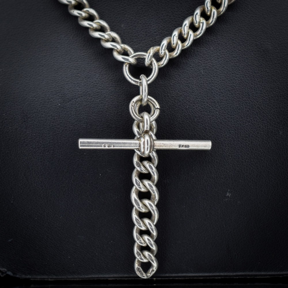 An antique sterling silver curb link Albert chain featuring a central T-bar attachment and double dog clip clasps. View III