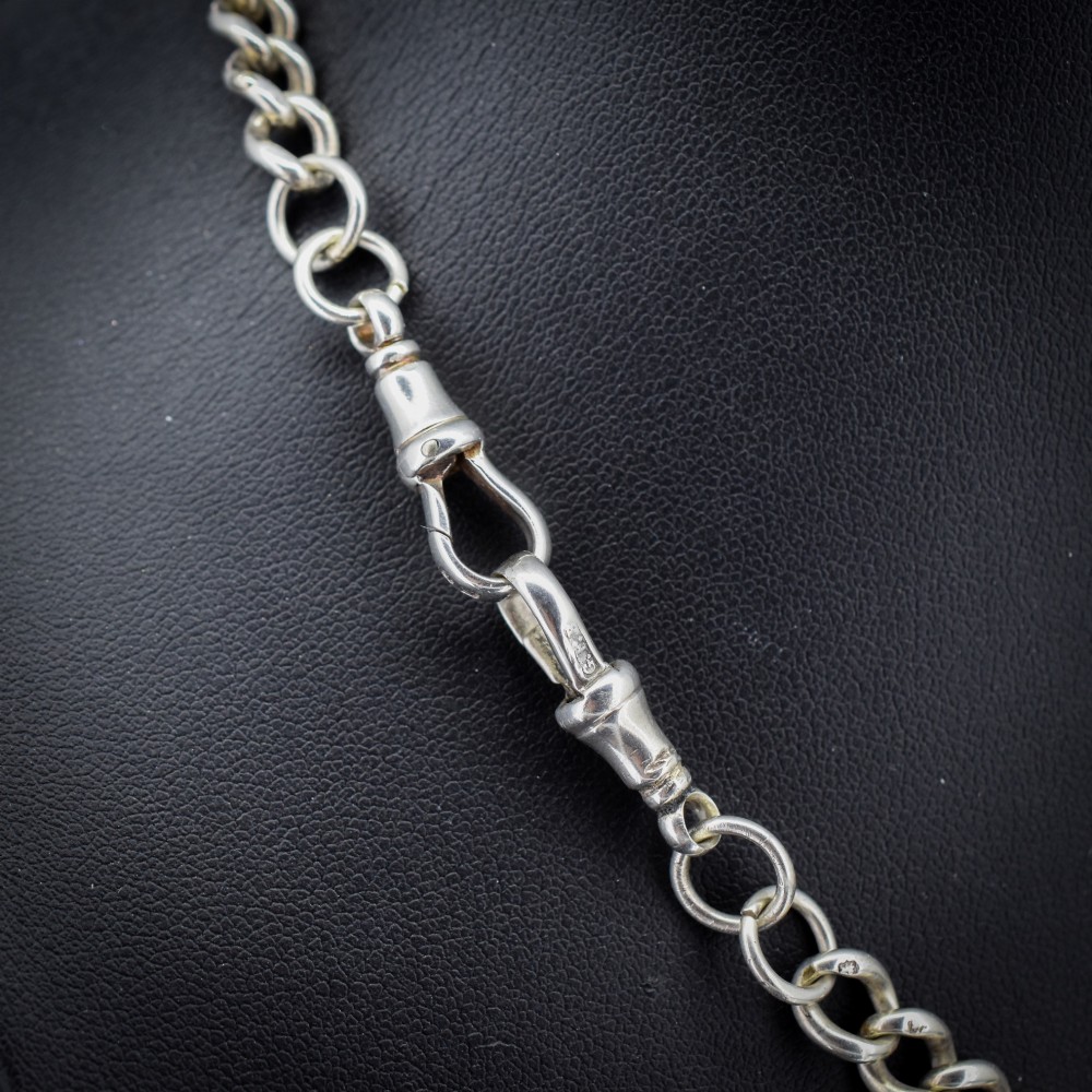 An antique sterling silver curb link Albert chain featuring a central T-bar attachment and double dog clip clasps. View V