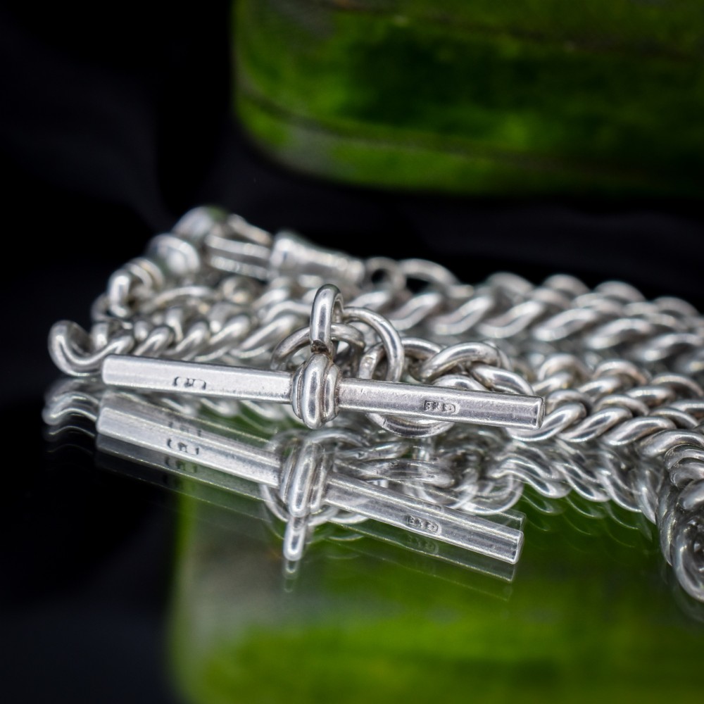 An antique sterling silver curb link Albert chain featuring a central T-bar attachment and double dog clip clasps. View VI