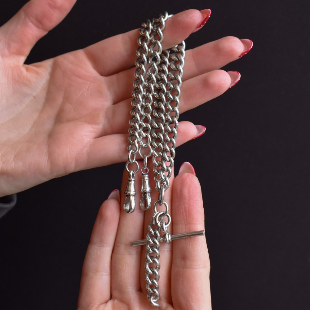 An antique sterling silver curb link Albert chain featuring a central T-bar attachment and double dog clip clasps. View IX