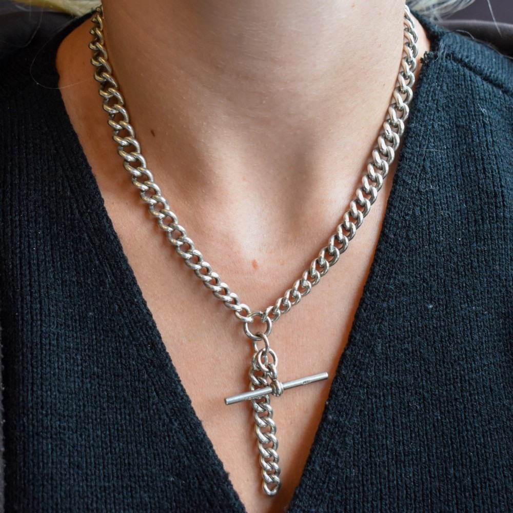 An antique sterling silver curb link Albert chain featuring a central T-bar attachment and double dog clip clasps. View XI
