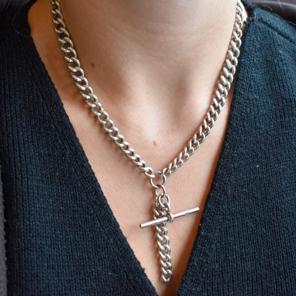 An antique sterling silver curb link Albert chain featuring a central T-bar attachment and double dog clip clasps. View XII