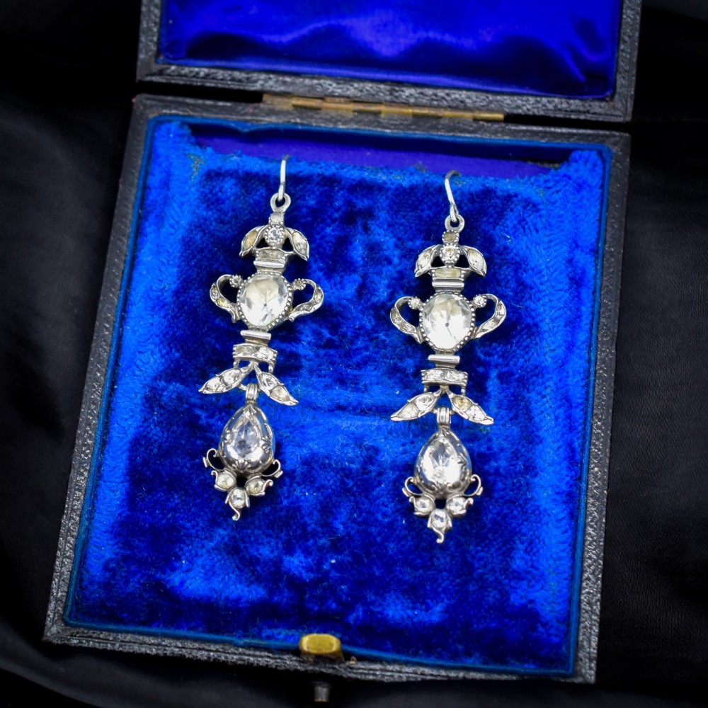 Pair of Georgian silver drop earrings featuring faceted clear rock crystal stones set into articulated silver mounts inside a velvet box. View II