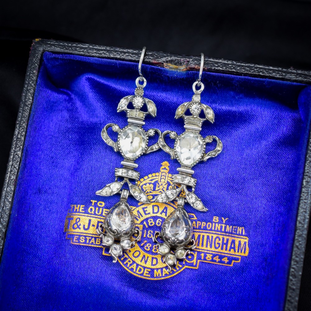 Pair of Georgian silver drop earrings featuring faceted clear rock crystal stones set into articulated silver mounts inside a velvet box. View III