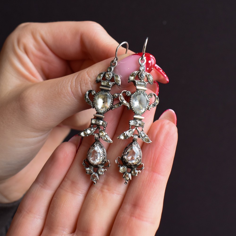 Pair of Georgian silver drop earrings featuring faceted clear rock crystal stones set into articulated silver mounts inside a velvet box. View IX