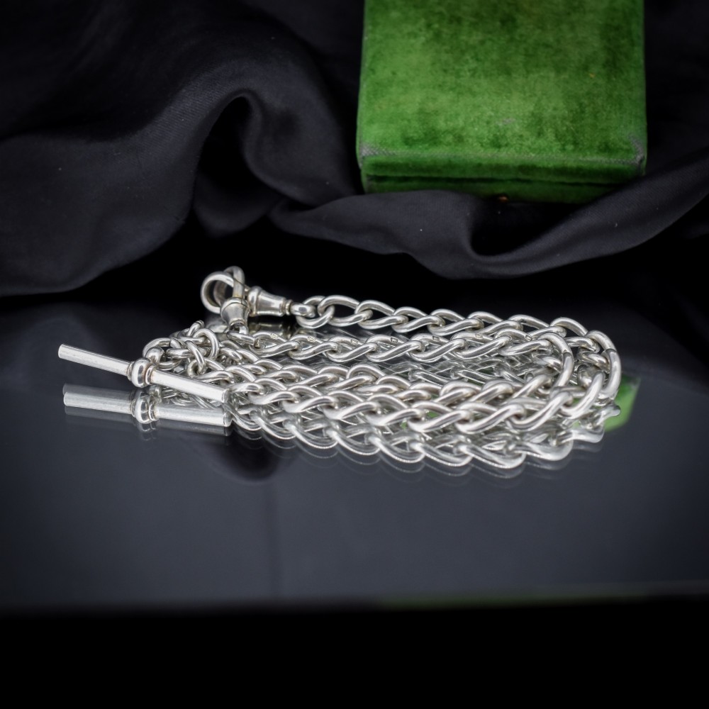 An Edwardian sterling silver Albert watch chain featuring heavy oval links, a central T-bar, and a dog clip clasp. View VI