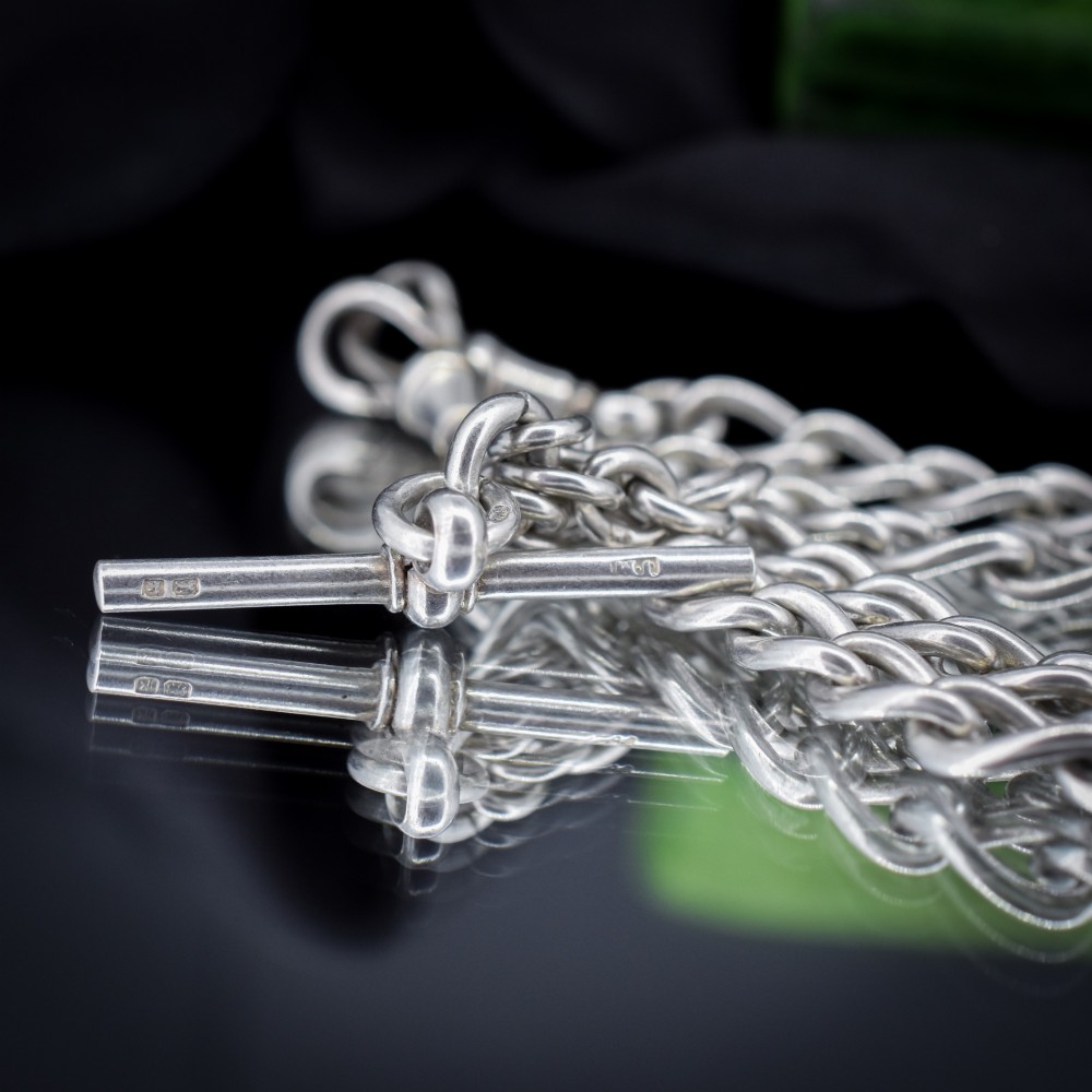 An Edwardian sterling silver Albert watch chain featuring heavy oval links, a central T-bar, and a dog clip clasp. View VII