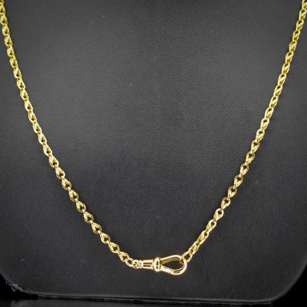 An antique yellow gold twenty-inch chain necklace featuring love knot links and a functional swivel dog clip fastener. View III
