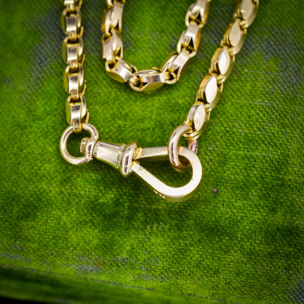 An antique 9ct yellow gold tulip link fancy chain necklace featuring a traditional dog clip fastener. View V