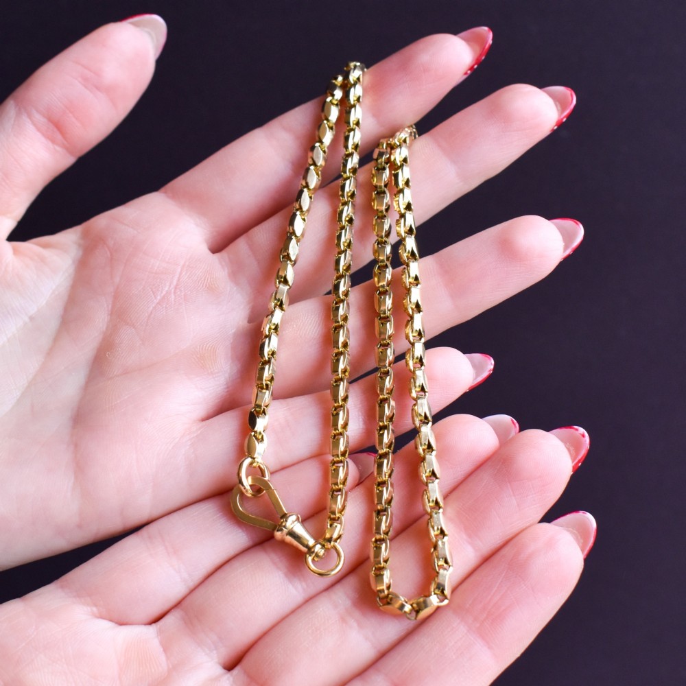 An antique 9ct yellow gold tulip link fancy chain necklace featuring a traditional dog clip fastener. View IX
