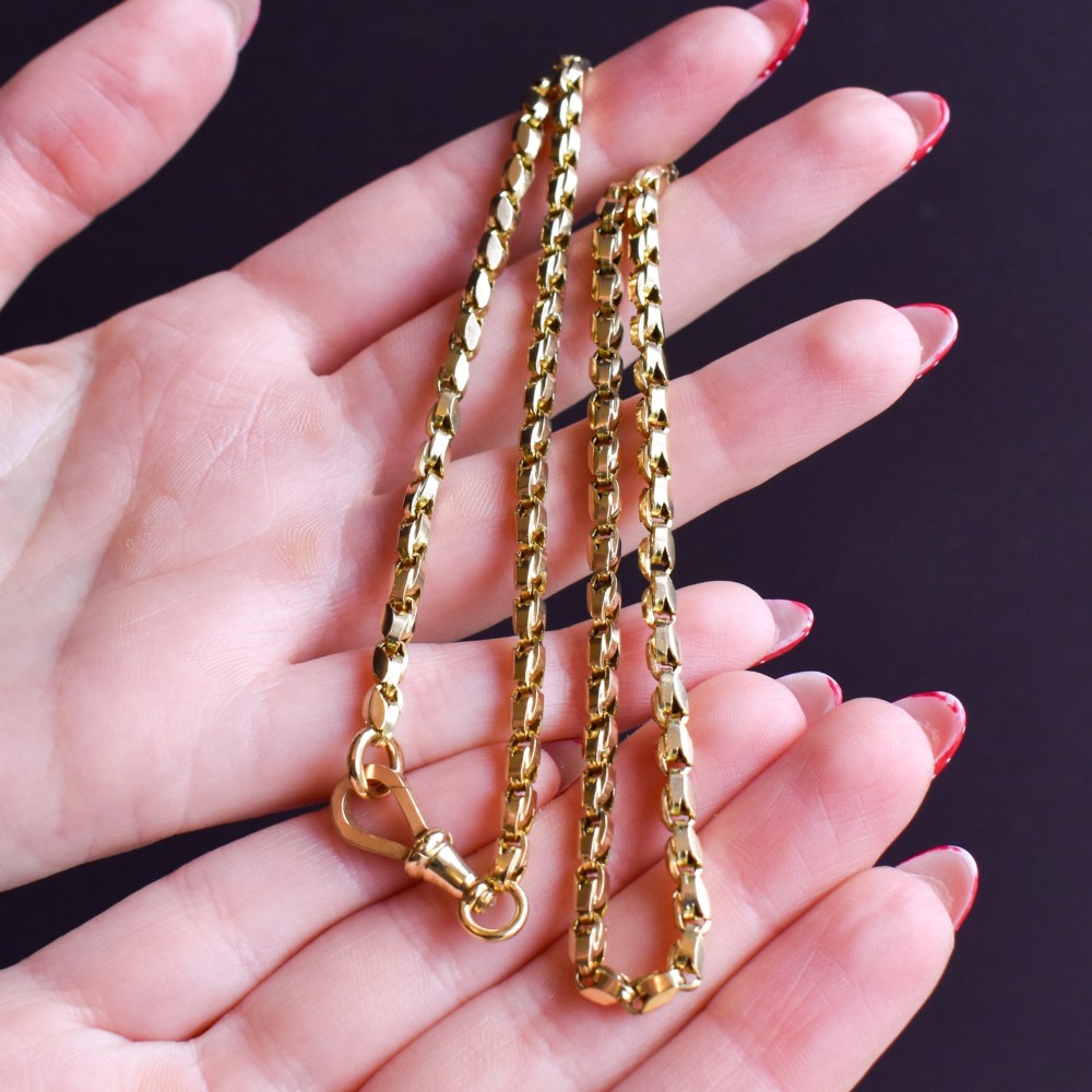 An antique 9ct yellow gold tulip link fancy chain necklace featuring a traditional dog clip fastener. View X