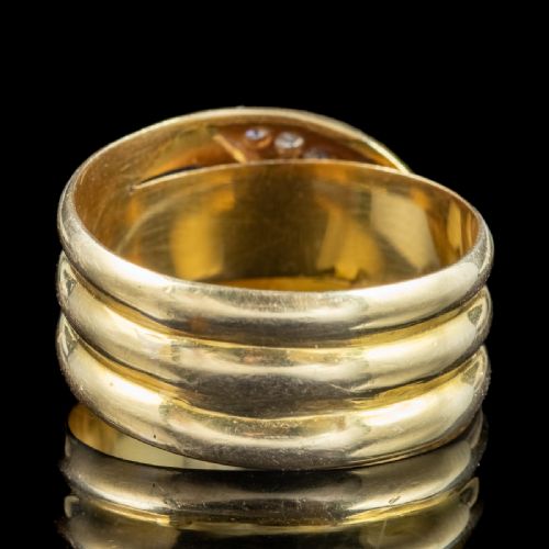 fig 1. An Art Deco yellow gold coiled snake ring set with five diamonds along the head, featuring visible internal hallmarks.