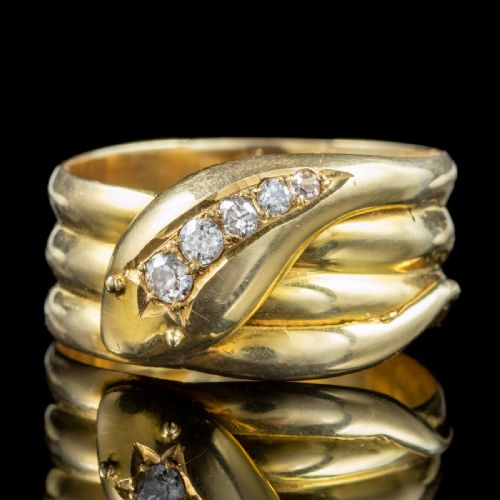 fig 4. An Art Deco yellow gold coiled snake ring set with five diamonds along the head, featuring visible internal hallmarks.