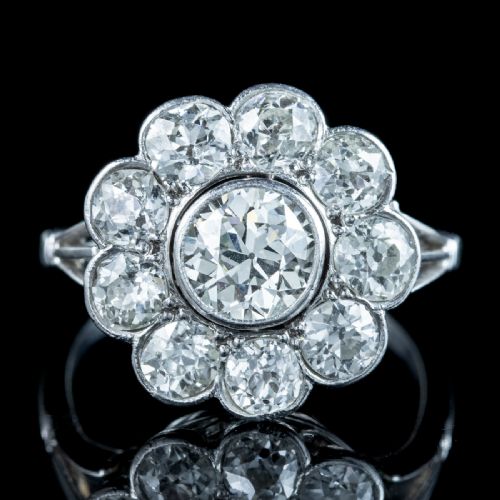 fig 3. An Edwardian platinum ring featuring a large old European cut central diamond surrounded by nine round diamonds forming a daisy cluster.