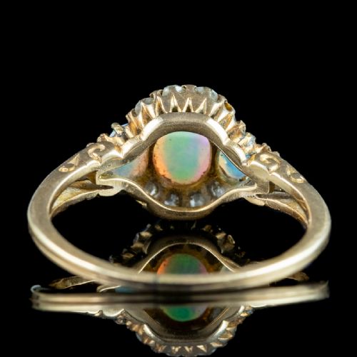 fig 1. A Victorian yellow gold ring set with three oval cabochon opals surrounded by small diamonds.